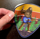 guitar sticker, guitar decal, colorado guitar sticker, acoustic guitar sticker, bigfoot holding a guitar sticker, bigfoot flipping a peace sign sticker, peace bigfoot sticker, guitar pick sticker, yeti sticker, sasquatch sticker, big foot sticker, idaho springs colorado decal, idaho springs colorado sticker, mountain decal, mountain sticker, mountain and river decal, mountain and river sticker, mountain illustration, colorful mountain drawing, colorado sticker, colorado decal
