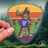 guitar sticker, guitar decal, colorado guitar sticker, acoustic guitar sticker, bigfoot holding a guitar sticker, bigfoot flipping a peace sign sticker, peace bigfoot sticker, guitar pick sticker, yeti sticker, sasquatch sticker, big foot sticker, idaho springs colorado decal, idaho springs colorado sticker, mountain decal, mountain sticker, mountain and river decal, mountain and river sticker, mountain illustration, colorful mountain drawing, colorado sticker, colorado decal