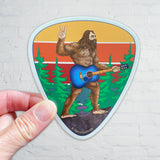 guitar sticker, guitar decal, colorado guitar sticker, acoustic guitar sticker, bigfoot holding a guitar sticker, bigfoot flipping a peace sign sticker, peace bigfoot sticker, guitar pick sticker, yeti sticker, sasquatch sticker, big foot sticker, idaho springs colorado decal, idaho springs colorado sticker, mountain decal, mountain sticker, mountain and river decal, mountain and river sticker, mountain illustration, colorful mountain drawing, colorado sticker, colorado decal