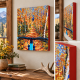 A colorful canvas wall art print showing an autumn forest path with bright orange and yellow foliage, blue sky, and a bicycle handlebar in the foreground, displayed in a styled room with wood trim and a window. The collage includes close-up views of the artwork side and different angles.  Mountain bike art, mountain biking artwork, mountain bike painting, colorado mountain bike art, autumn aspen painting, fall foliage artwork, original acrylic mountain bike art, rockies bicycle painting, hidden detail art