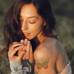 Woman with a butterfly tattoo on her shoulder in a natural setting.  tattoo certificate, tattoo permission slip, tattoo permission ticket, tattoo permission, tattoo stencil, tattoo flash, tattoo print, tattoo art, commission tattoo, custom tattoo, personalized tattoo