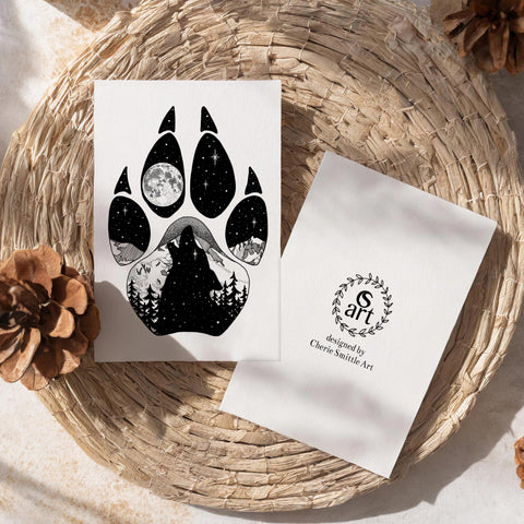 Wolf Paw Greeting Card: features a wolf paw with a wolf howling at a full moon with a hidden big & little dipper; wolf howling at the moon, colorado mountains, constellation, big dipper and little dipper constellation, wolf silhouette, wolf paw silhouette, wolf footprint silhouette, Wolf Paw Silhouette Greeting Card, Wolf Paw Silhouette card
