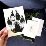 Wolf Paw Greeting Card: features a wolf paw with a wolf howling at a full moon with a hidden big & little dipper; wolf howling at the moon, colorado mountains, constellation, big dipper and little dipper constellation, wolf silhouette, wolf paw silhouette, wolf footprint silhouette, Wolf Paw Silhouette Greeting Card, Wolf Paw Silhouette card