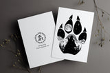 Wolf Paw Greeting Card: features a wolf paw with a wolf howling at a full moon with a hidden big & little dipper; wolf howling at the moon, colorado mountains, constellation, big dipper and little dipper constellation, wolf silhouette, wolf paw silhouette, wolf footprint silhouette, Wolf Paw Silhouette Greeting Card, Wolf Paw Silhouette card
